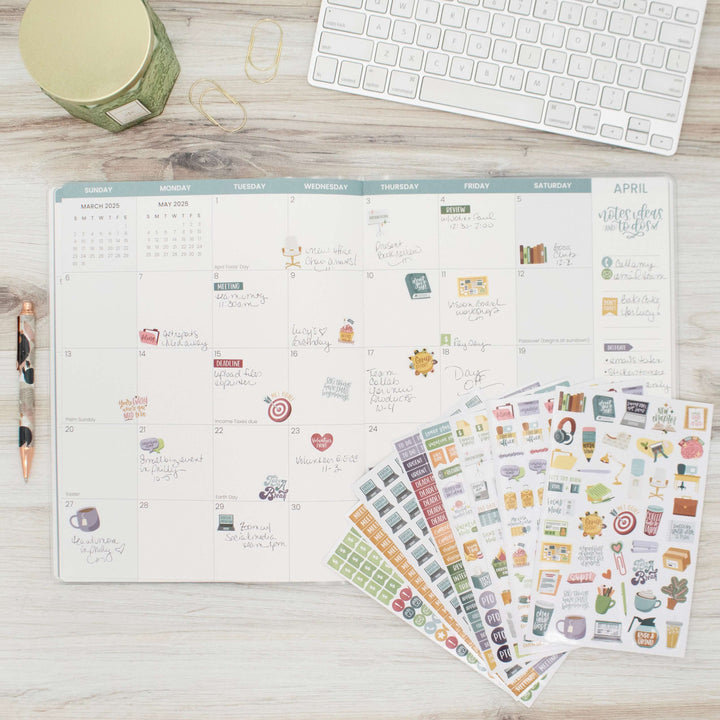 Bloom Workday Essentials Planner Stickers Pack displayed with a monthly calendar on a desk for organizing work tasks.