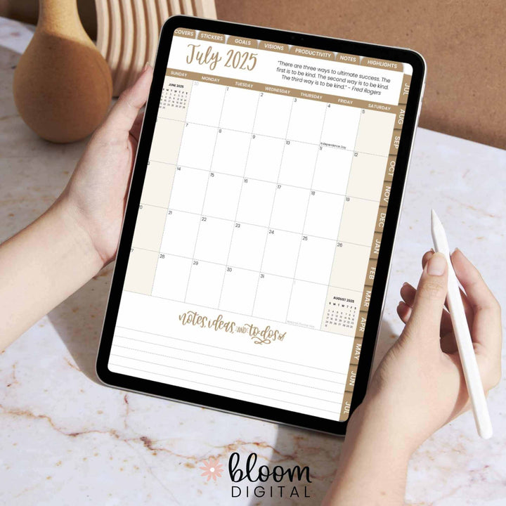 Hands holding an iPad displaying a digital planner page for July 2025 by Bloom Daily Planners.