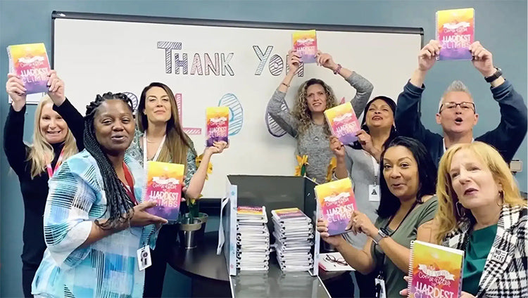 The women of Arouet opening the first copies of the planner they created!