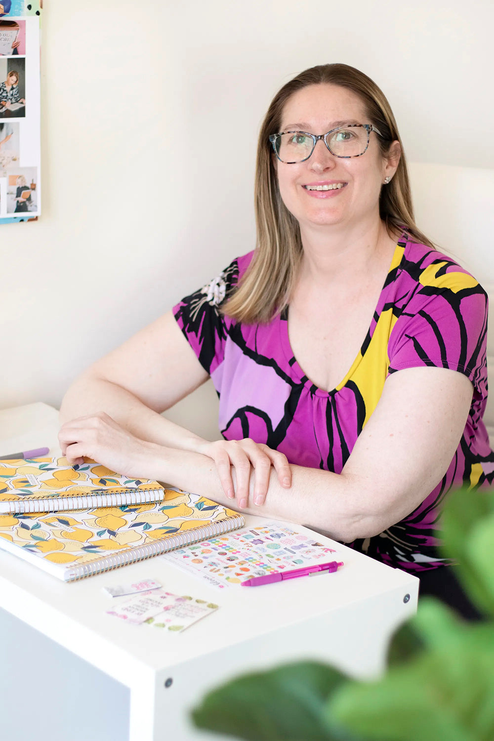 girl with glasses sitting at desk with lemon planners