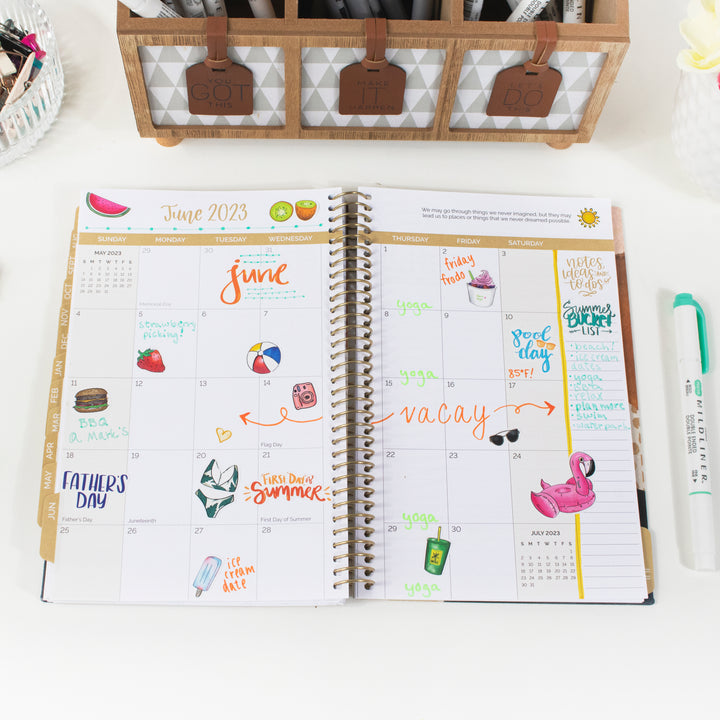 Colorful June 2023 planner spread featuring vintage holiday hand-drawn stickers and seasonal themes.
