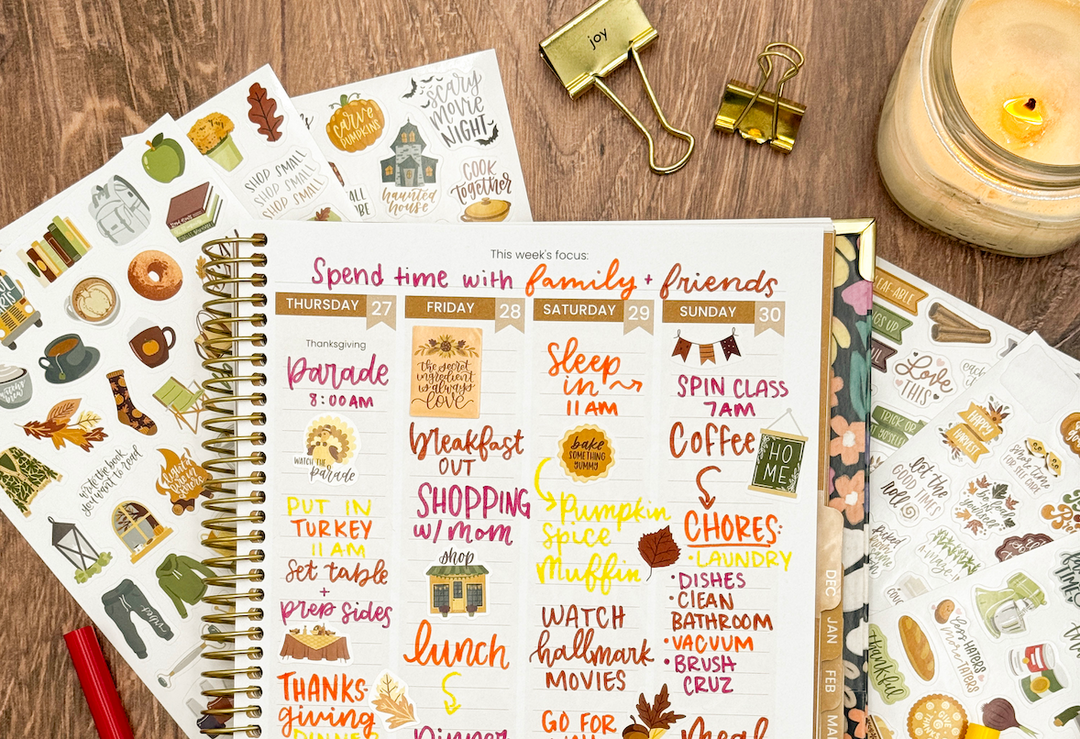 A bloom weekly planner spread decorated for Thanksgiving with colorful markers and stickers.