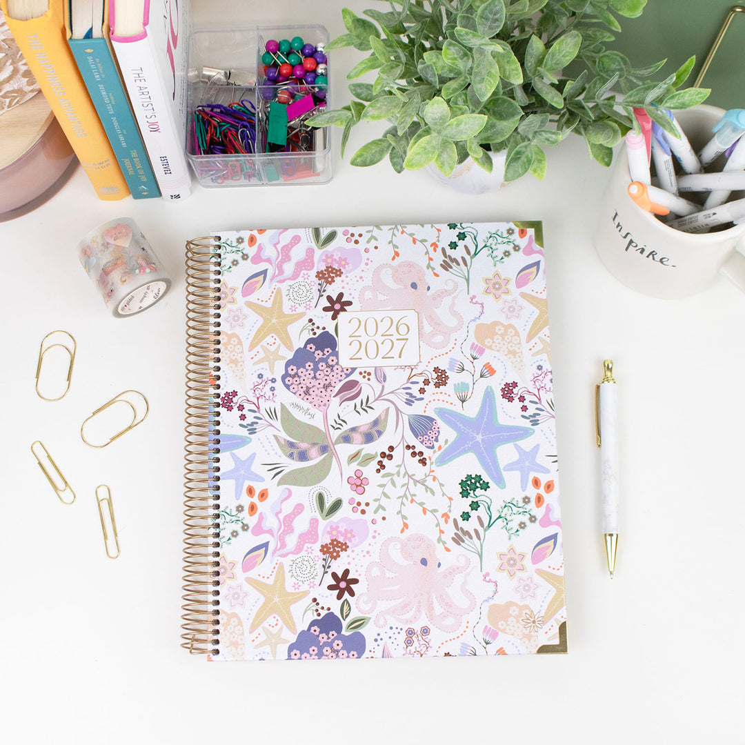 2026-2027 planner with floral design on a desk with stationery items