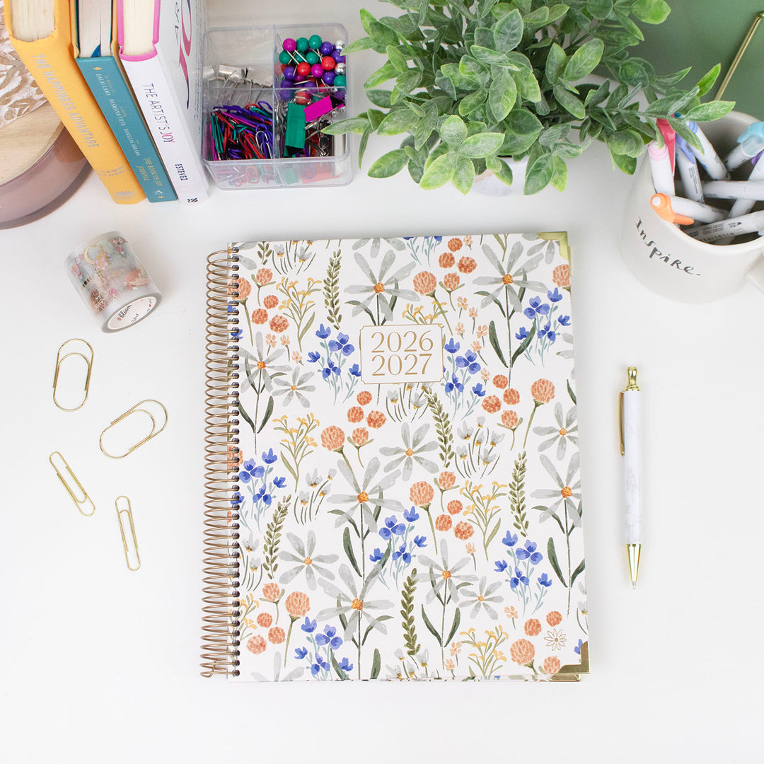Floral-patterned 2026-2027 planner on a desk with stationery items