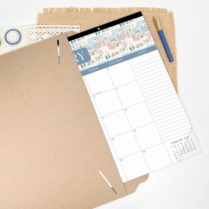 Calendar planner on a textured surface with a pen and paper.