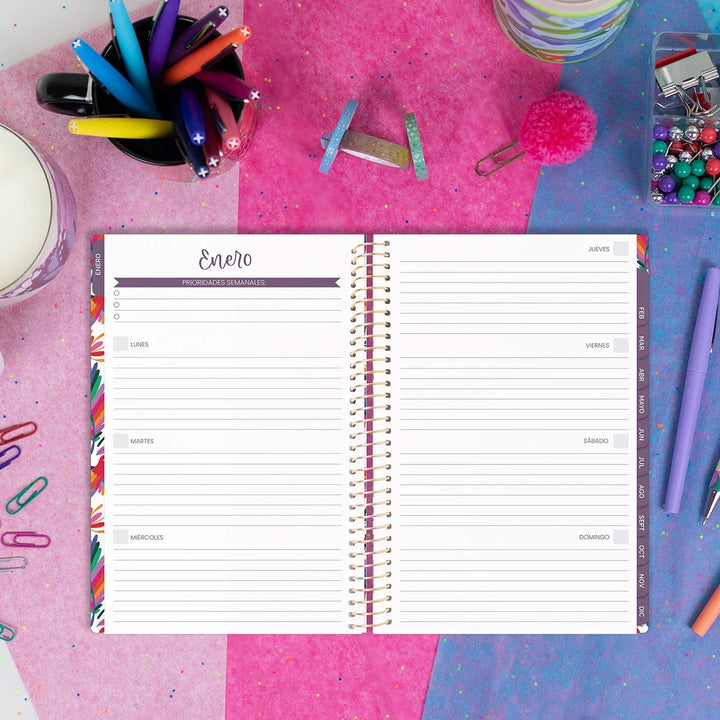 Open planner on a colorful background with stationery items
