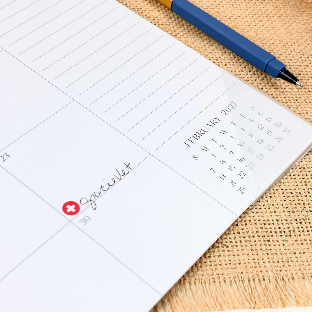 Calendar page with a pen on a textured surface