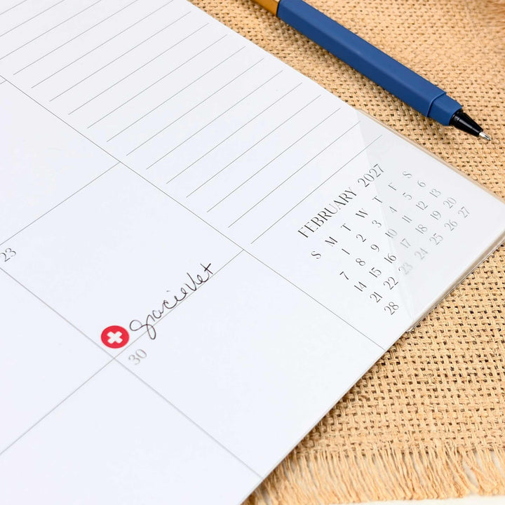 Calendar page with a pen on a textured surface