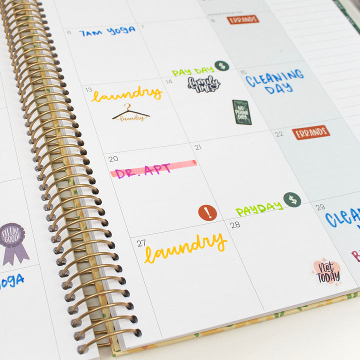 Calendar page with colorful stickers on a white surface