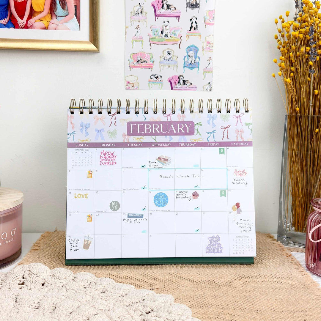 February 2027 calendar page filled with stickers, handwritten events, and appointments.