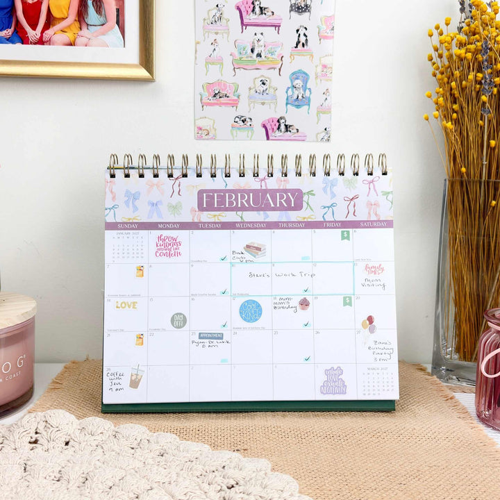 February 2027 calendar page filled with stickers, handwritten events, and appointments.