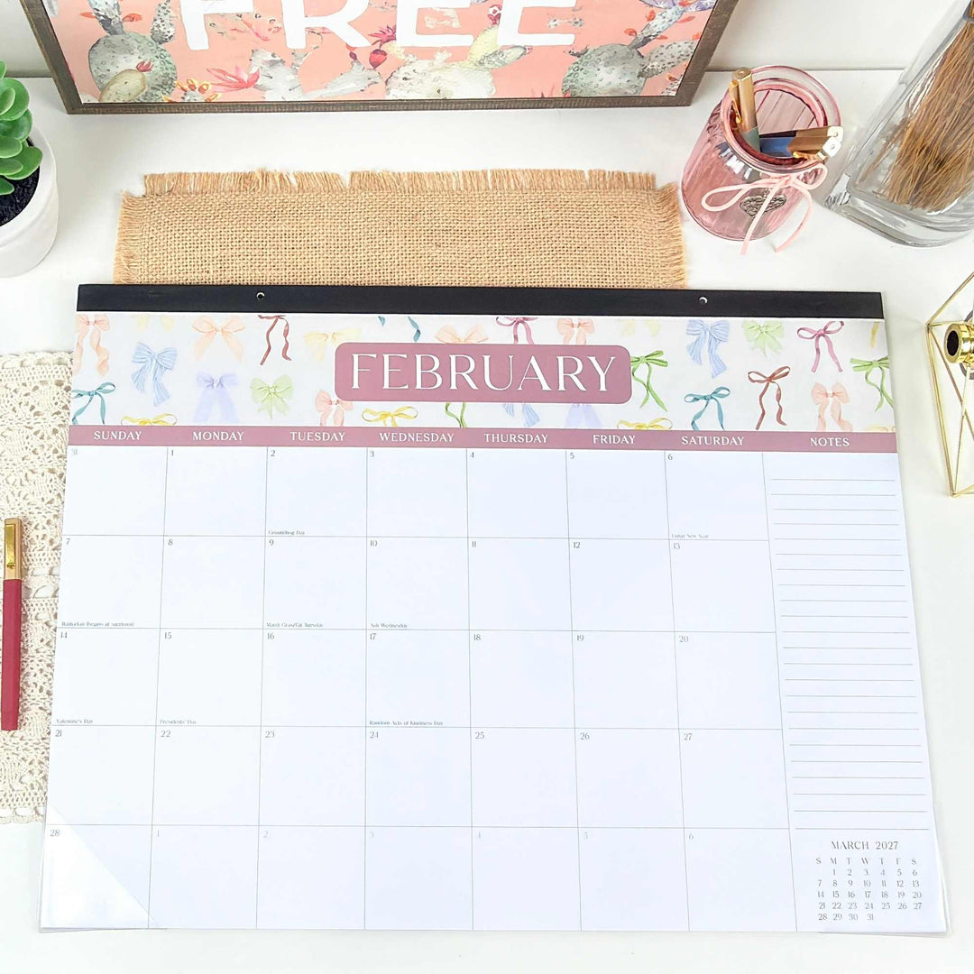February calendar on a desk with office supplies