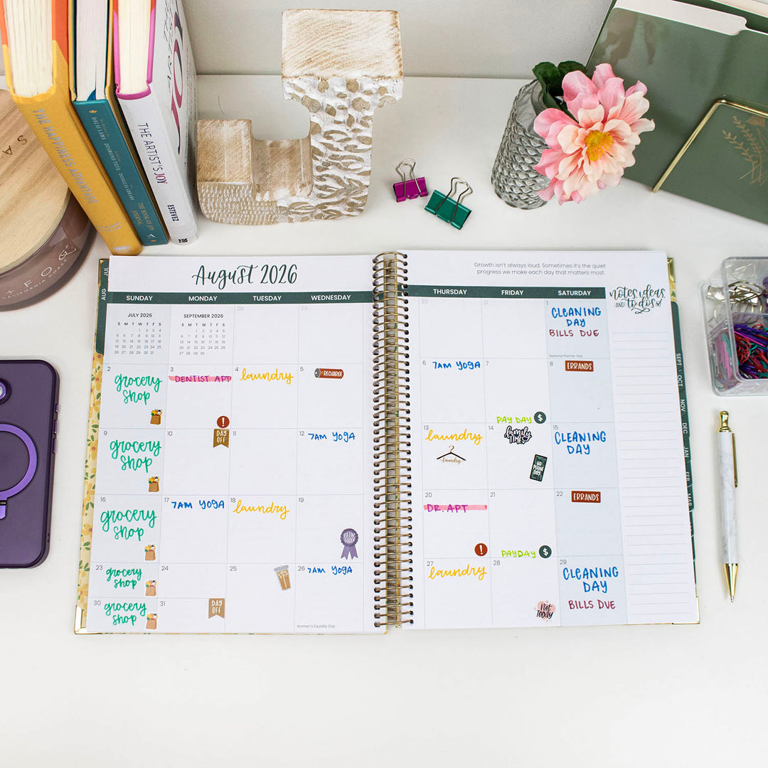 Open planner with August 2026 schedule on a desk with stationery items.