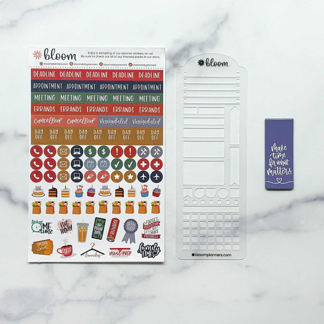 Bloom planner sticker kit on a white marble background, featuring a colorful sticker sheet, a clear plastic date-grid template, and a purple sticky note.