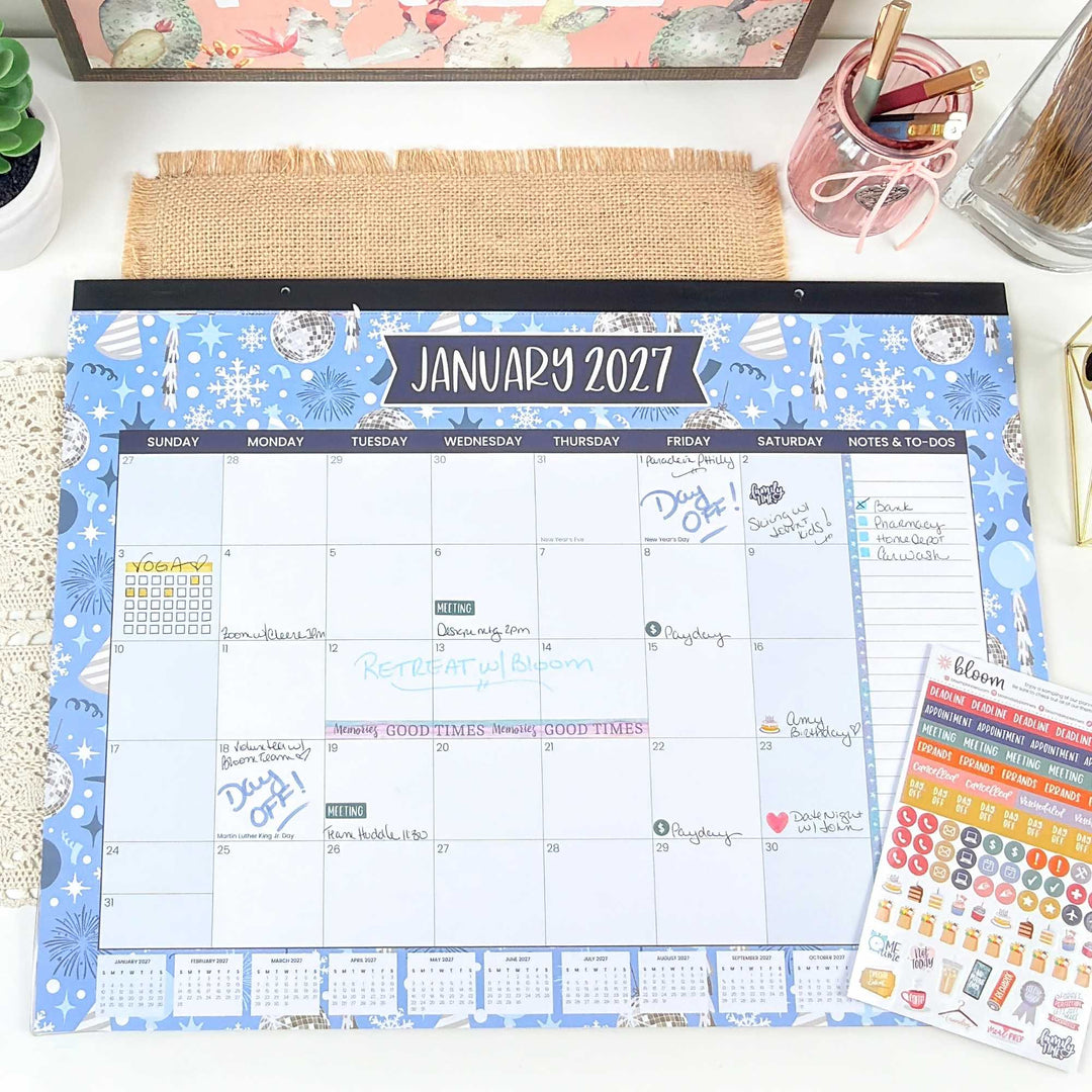 January 2027 calendar on a desk with stationery items