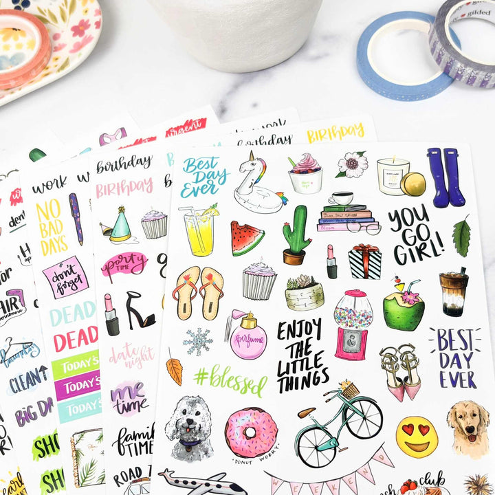 Collection of colorful everyday stickers on a white background with a mug and tape in the corner.