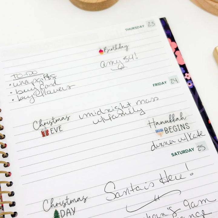 Weekly planner page with handwritten holiday celebration dates and sticker accents