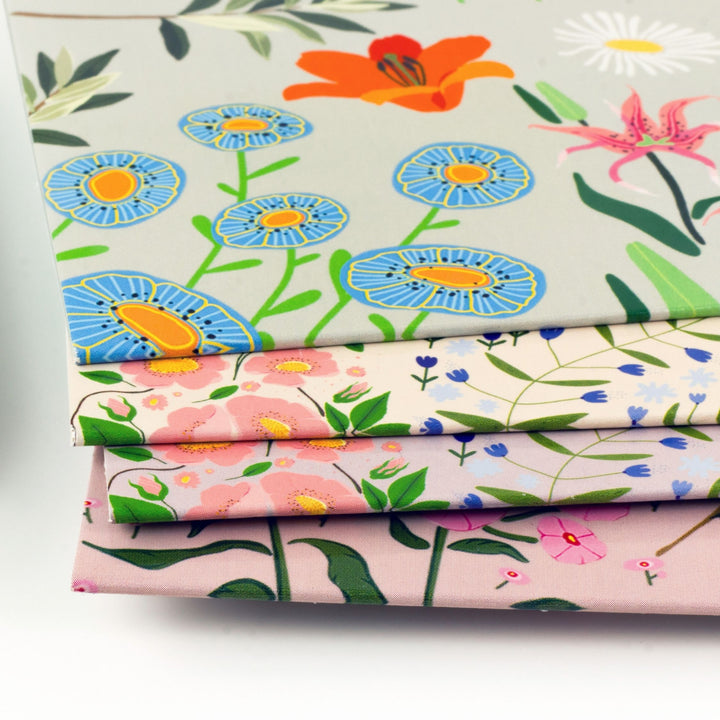 Stack of floral fabric swatches on a white background