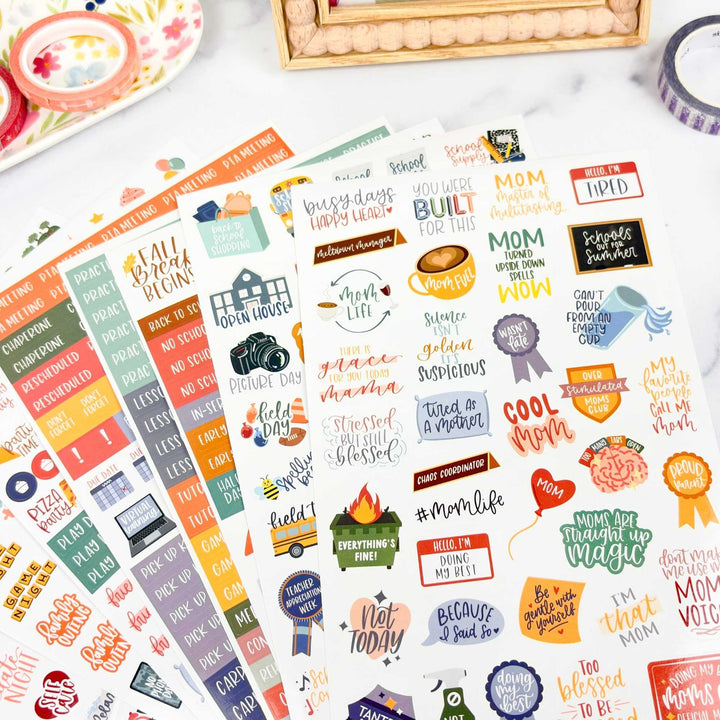 Collection of colorful mom themed planner stickers with various designs and text on a white surface.