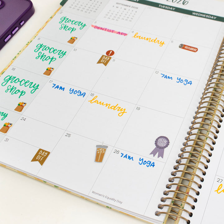 Calendar with stickers for daily activities on a white surface