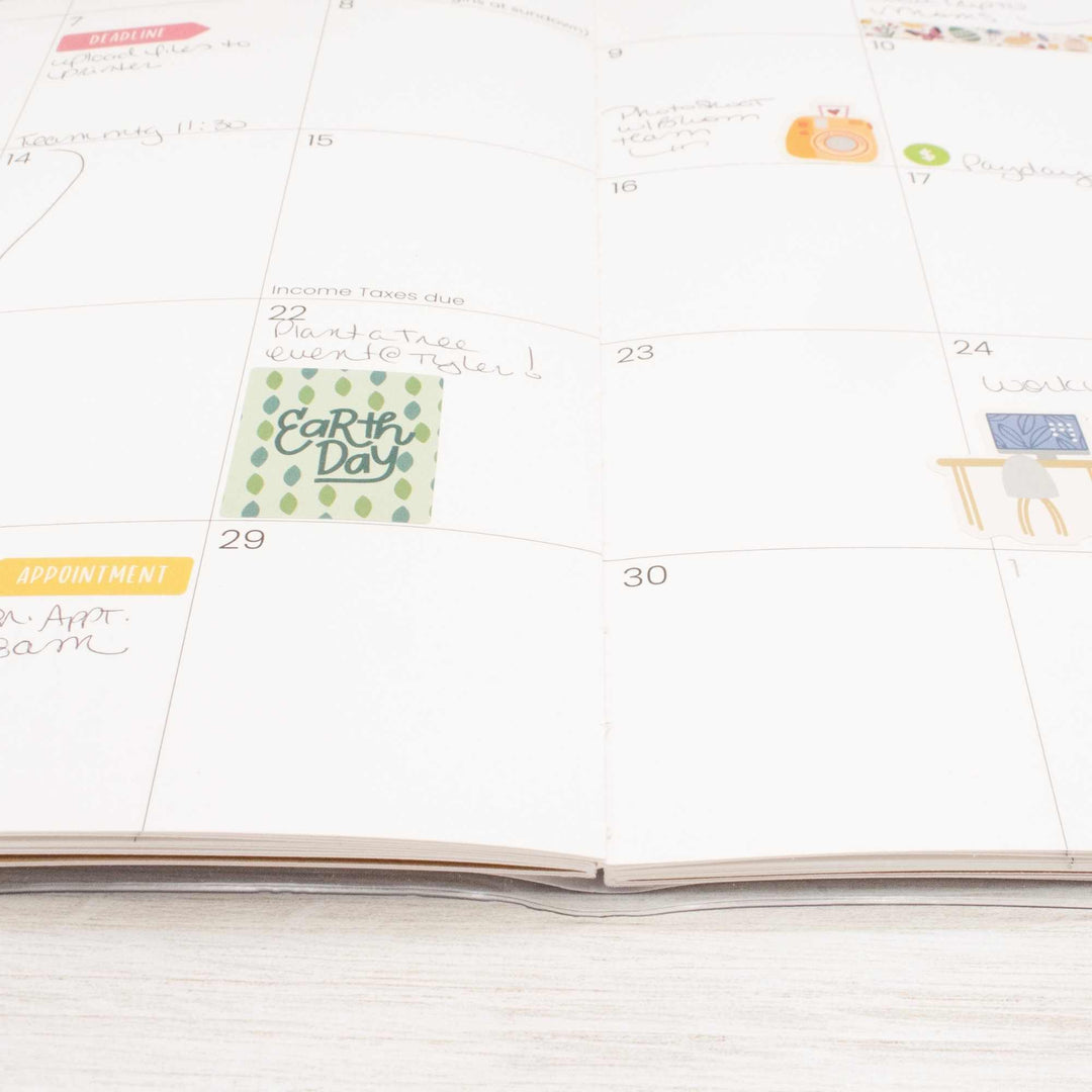 Calendar with Earth Day sticker on a white surface