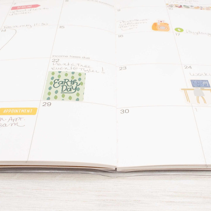 Calendar with Earth Day sticker on a white surface