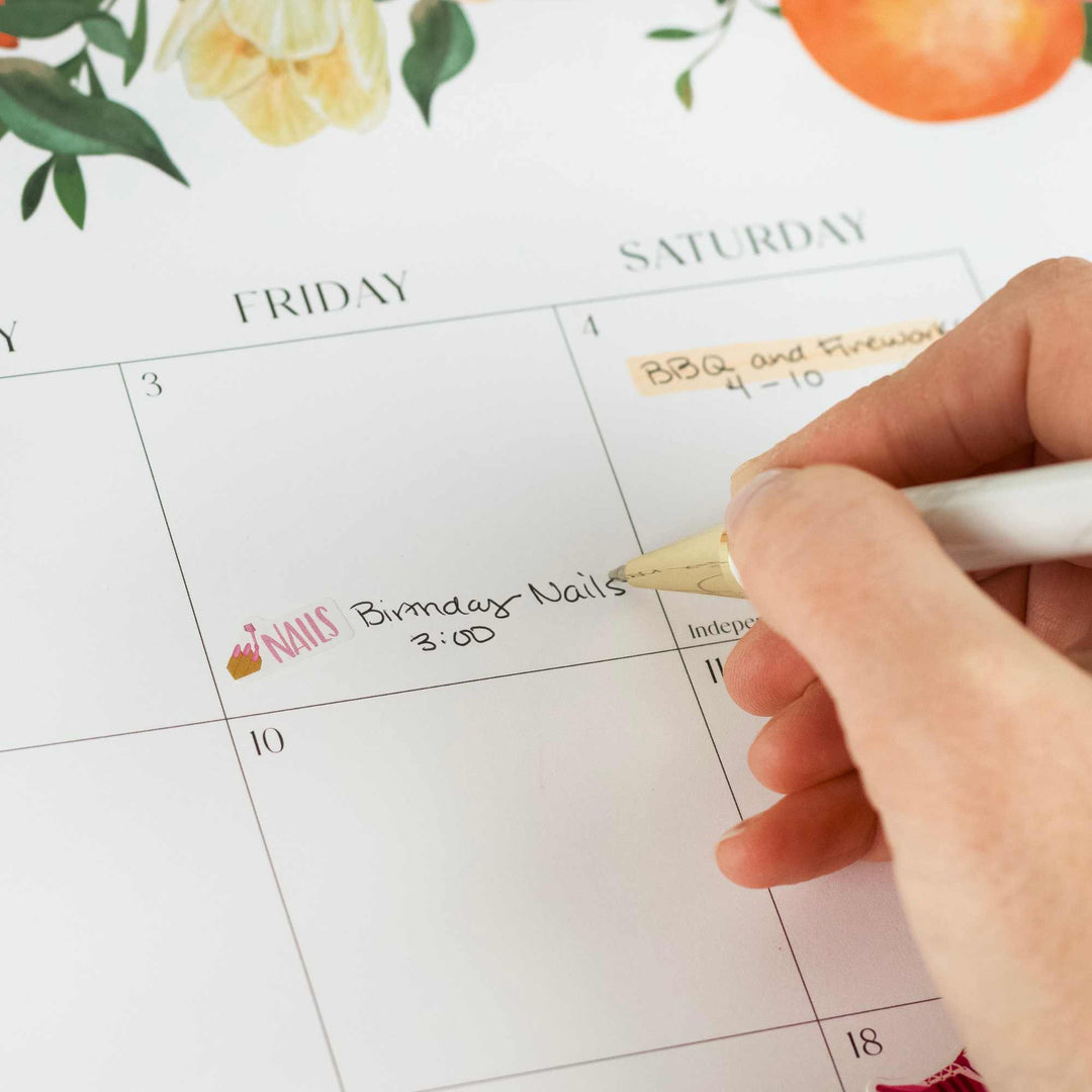 Hand writing on a calendar with decorative elements