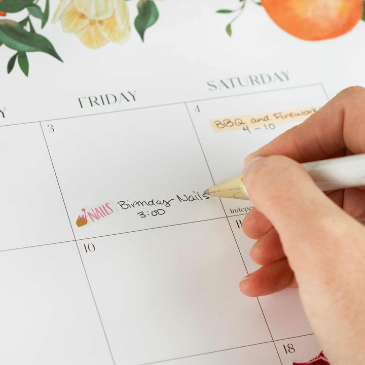 Hand writing on a calendar with decorative elements