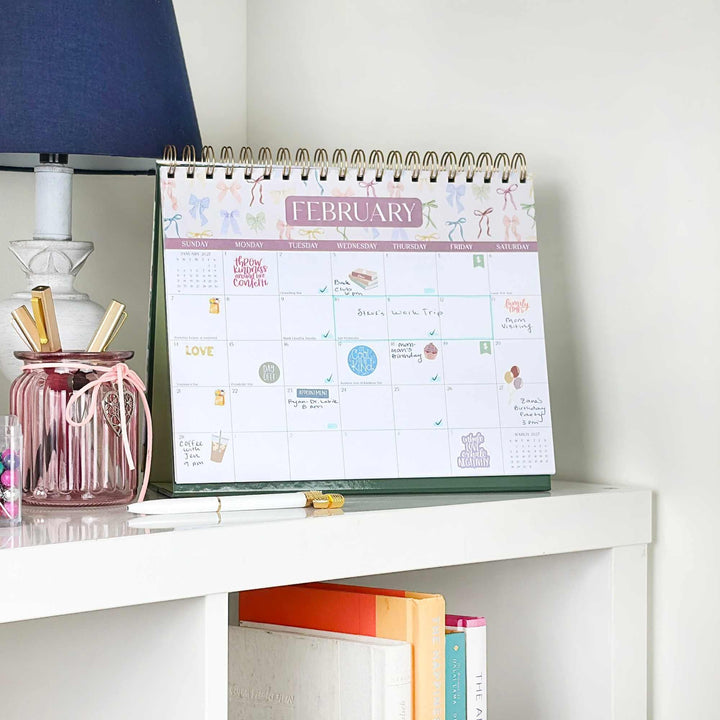 February 2027 calendar page filled with stickers, handwritten events, and appointments.