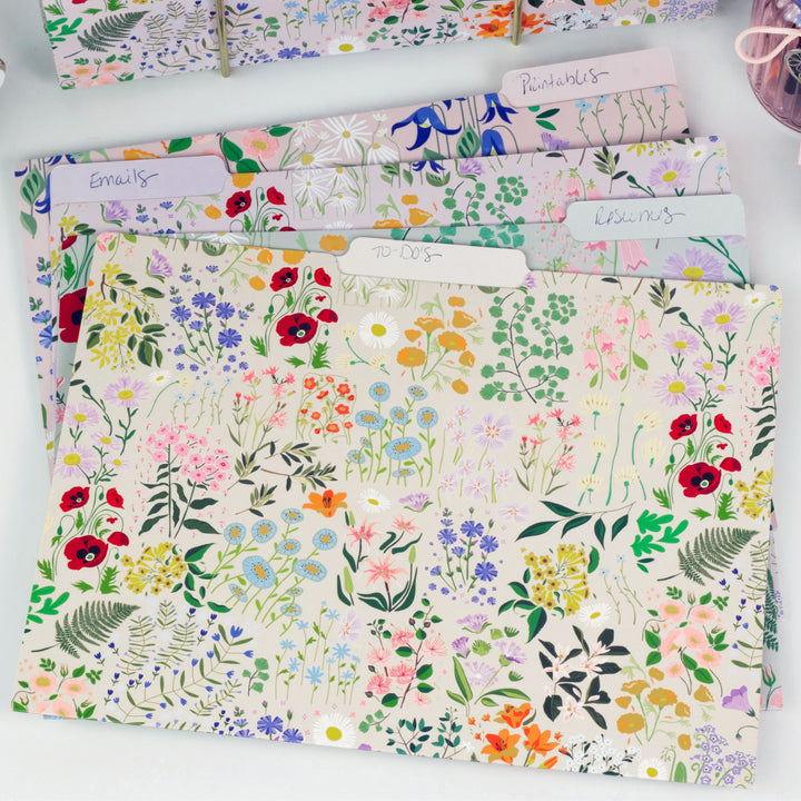Set of floral-patterned folders on a white surface