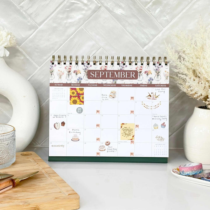September view of a standing flip calendar in a family kitchen setting. 