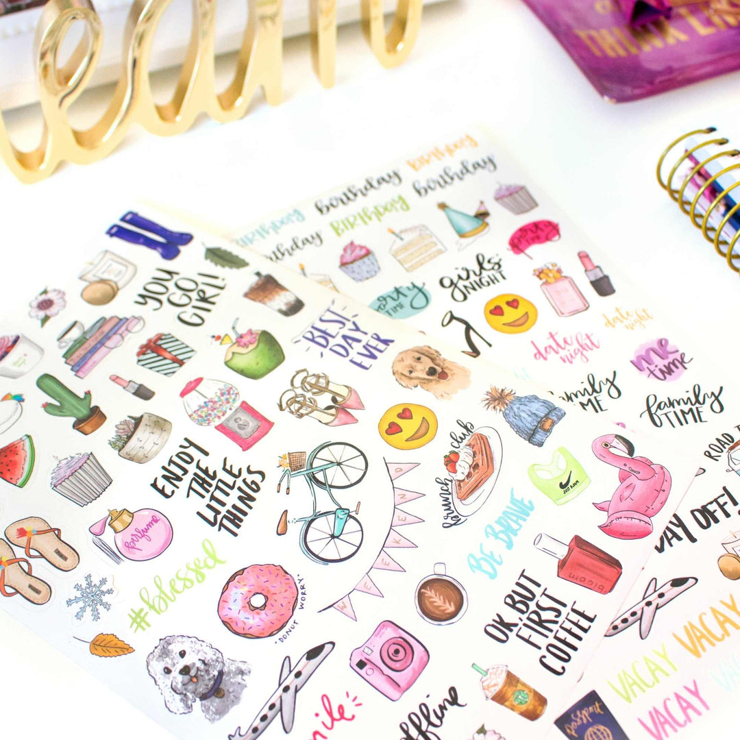 Sheet of colorful stickers with various designs and text on a white background.