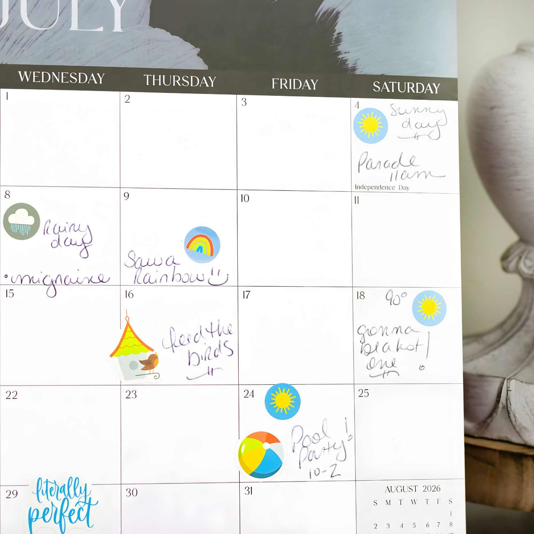 Calendar with hand-written notes and colorful symbols, leaning against a decorative wall piece.