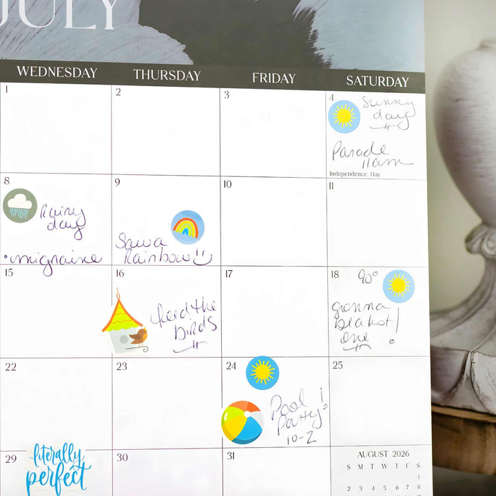 Calendar with hand-written notes and colorful symbols, leaning against a decorative wall piece.