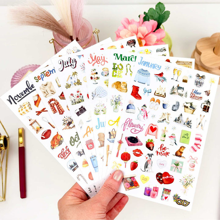 Six sticker sheets laid flat, organized by month from January through December