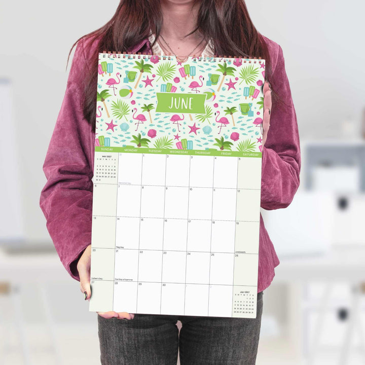 Person holding a colorful calendar with June on it