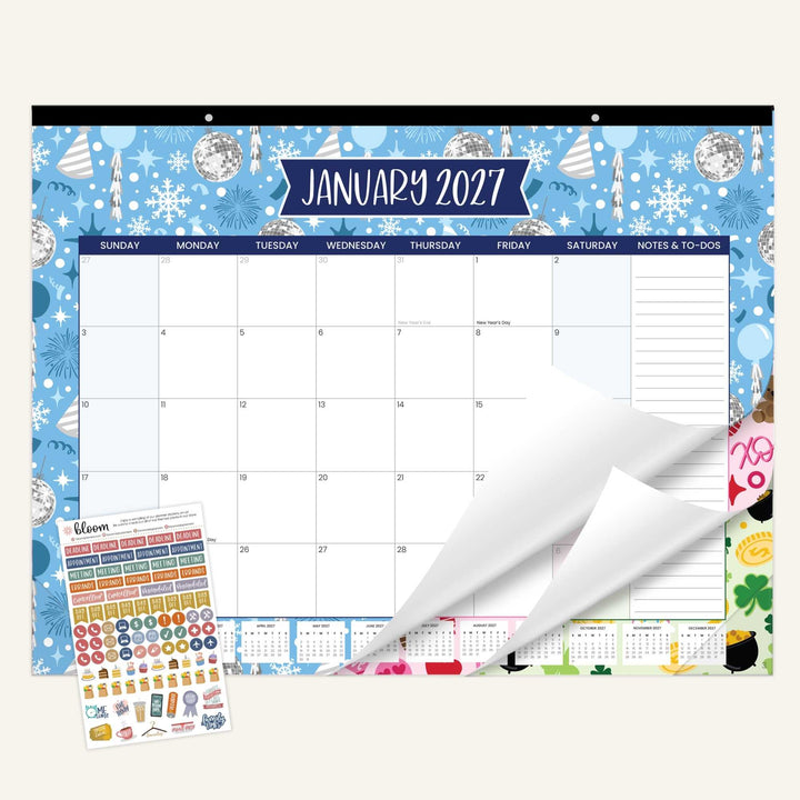 Wall calendar with January 2027 layout, stickers, and a roll of paper on a white background.