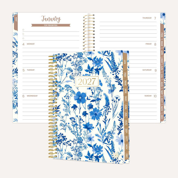 Blue and White Floral design on A 2027 bloom pocket planner in front of a horizontal weekly view.