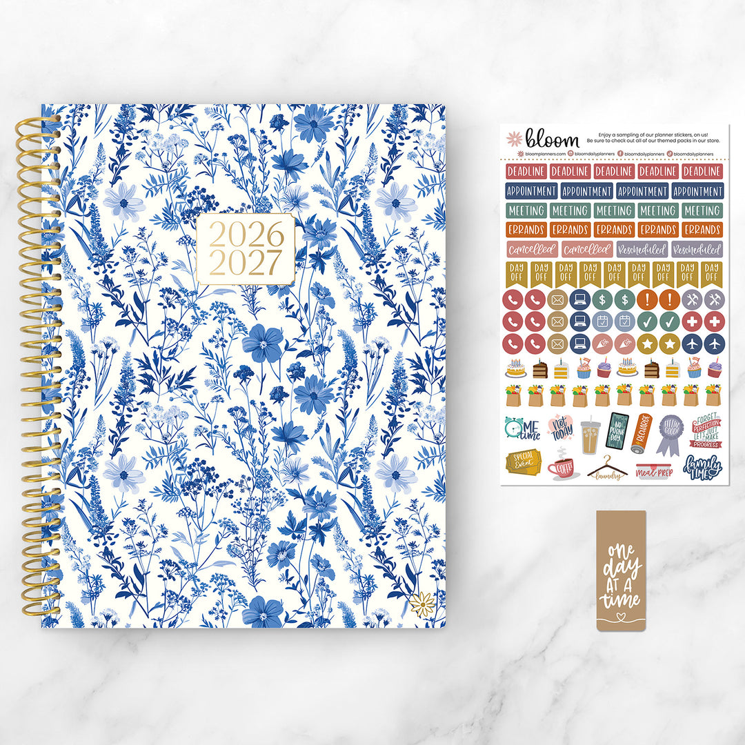 Floral-patterned planner with stickers on a white background