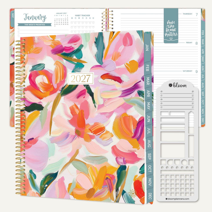 A 2027 spiral-bound planner shown open with floral cover art in pink, orange, yellow, and teal, alongside interior page spreads and a white plastic insert tool. The visible brand on the insert is bloom.