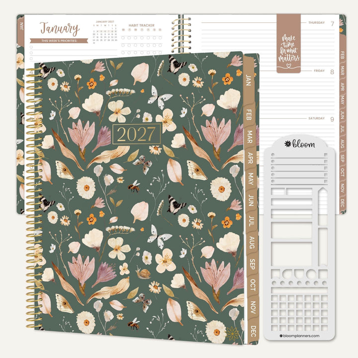 A 2027 spiral-bound planner shown open with floral cover pages, weekly tabs, and a white bloom brand insert tool on a light beige background.