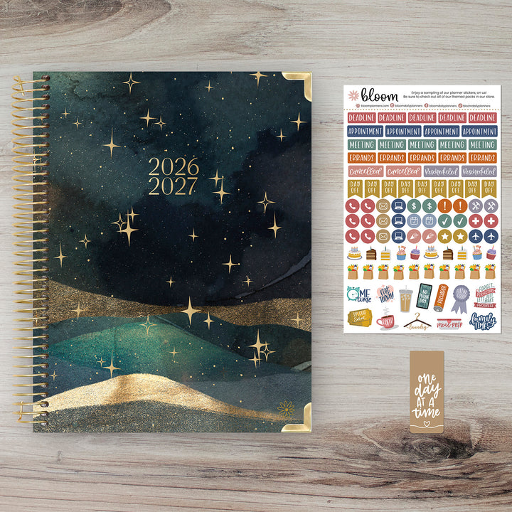 2026-2027 planner with starry night design on a wooden surface