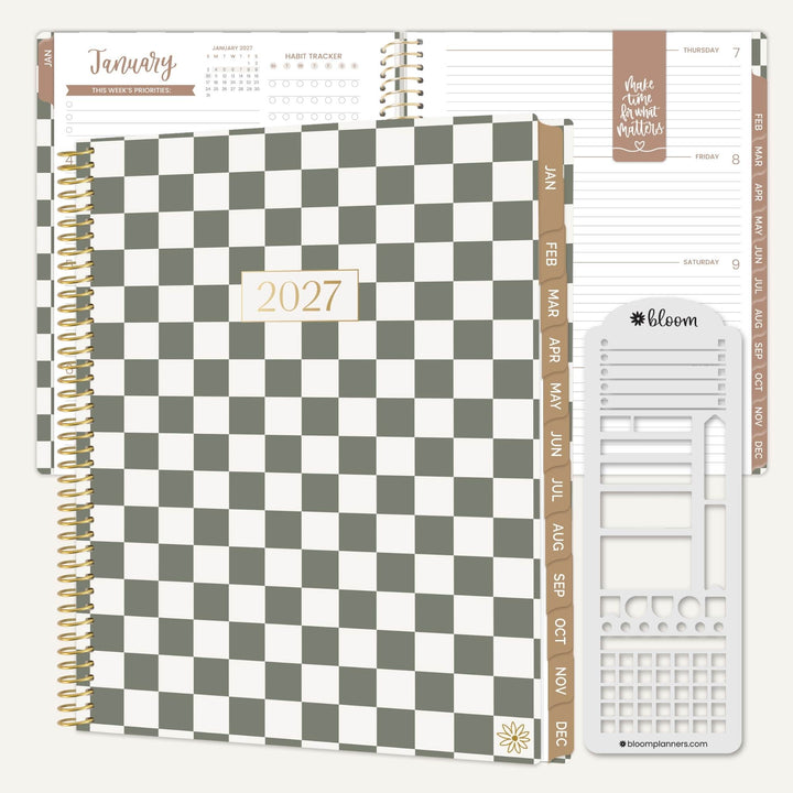 A 2027 spiral-bound planner shown open with interior pages and a white accessory sheet. The cover has a large gray-and-white checkerboard pattern with a small gold-toned 2027 label.
