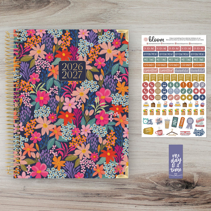 Floral 2026-2027 planner with stickers on a wooden surface