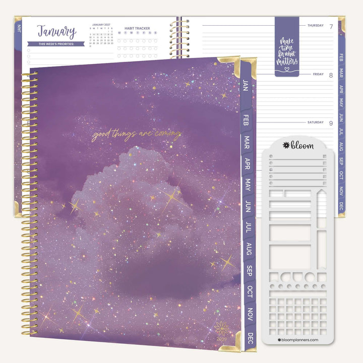A spiral-bound planner shown open to a January page, with a purple glittery cover in front and white insert sheets and tabs visible. The cover has gold foil text reading 'good things are coming,' and the planner branding 'bloom planners' is visible on the insert.