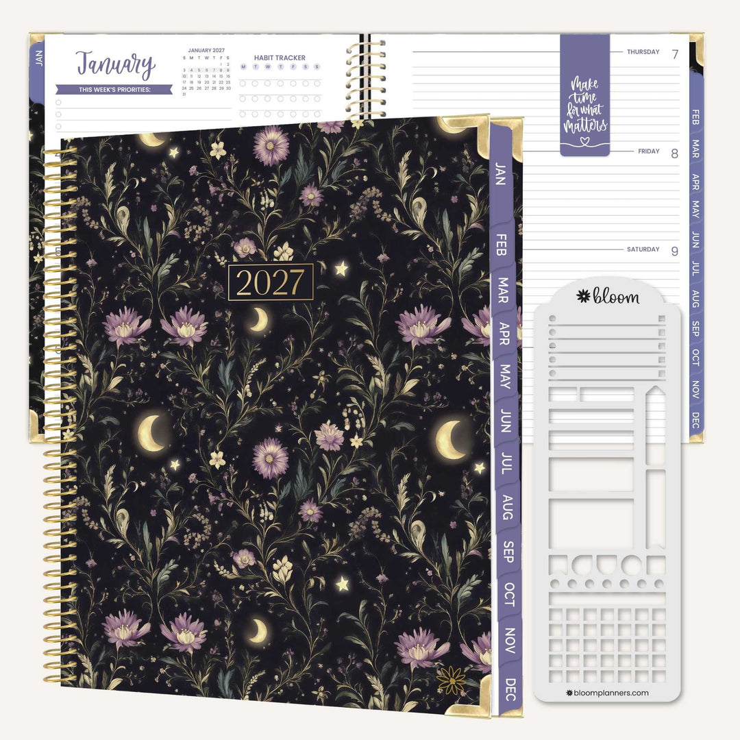 A 2027 spiral-bound planner shown open to a weekly layout page, with the front cover featuring a dark floral and moon pattern. The planner includes purple weekday tabs, gold spiral binding, and a white insert page with planner sections.