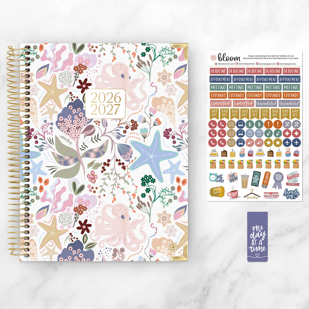 Floral-patterned planner with stickers on a white background
