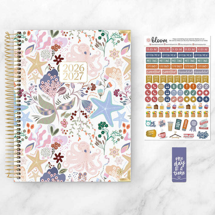 Floral-patterned planner with stickers on a white background