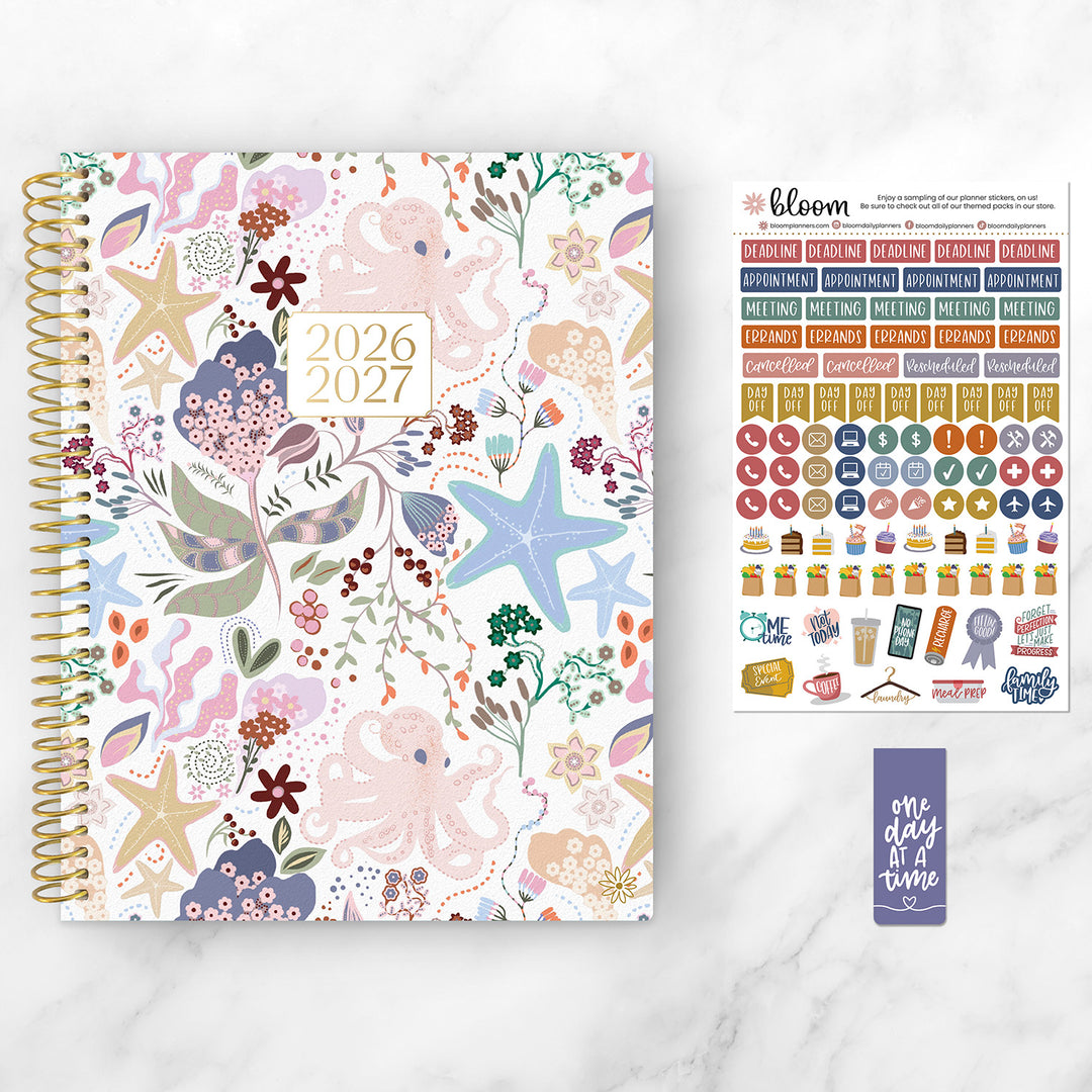 Floral-patterned planner with stickers on a white background