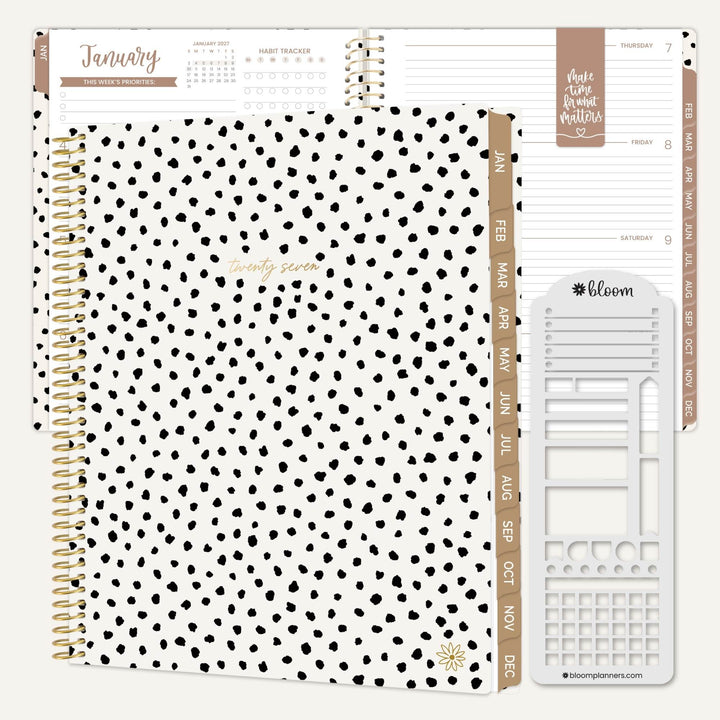 A spiral-bound planner set shown open on a light neutral background, featuring a white cover with black irregular dot pattern, rose-gold-toned divider tabs, and a white insert page set. The visible brand name 'bloom planners' appears on the insert.
